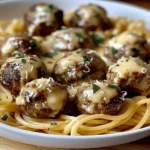 GArlic Butter Meatballs served over creamy Parmesan linguine